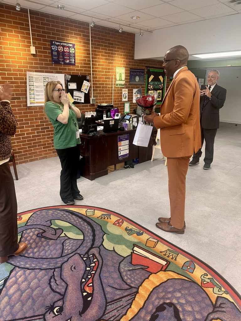 District Leader, Eric Jeffcoat, surprising GEM Ashley MacDonald with flowers.