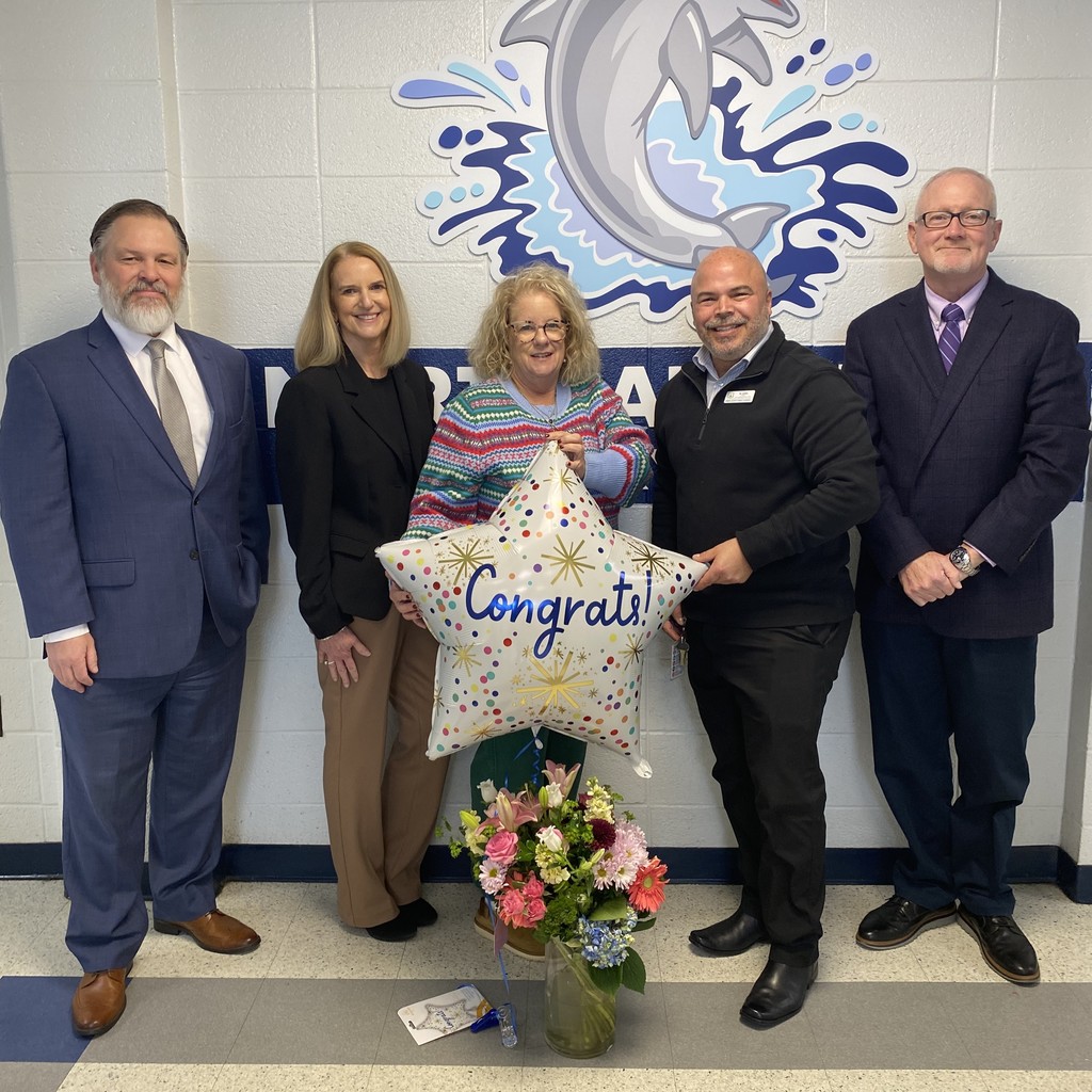 District Leaders congratulating GEM, Karen Ulmer, with a balloon and flowers.
