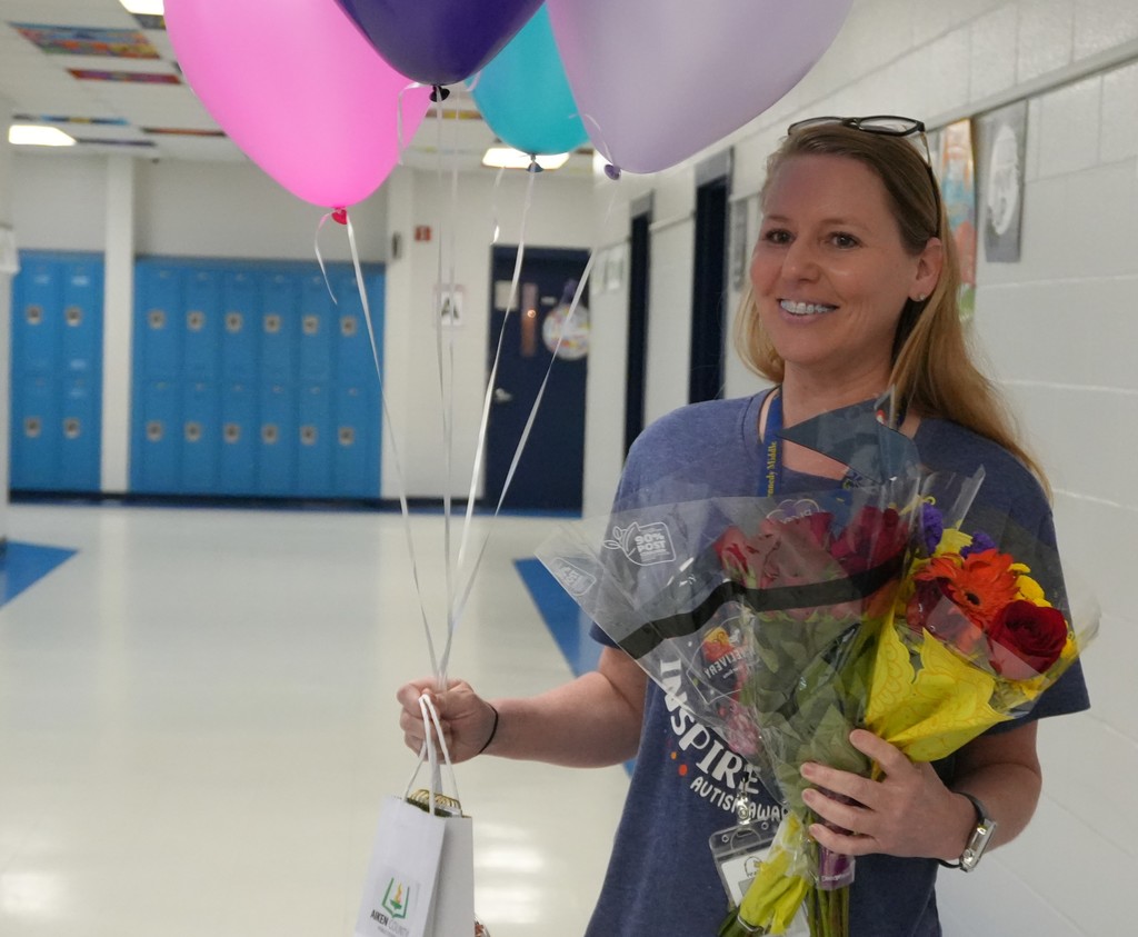 Nikkie Powell being surprised with balloons and flowers for GEM Honor Court.