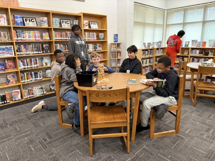 students sitting at a table talking 
