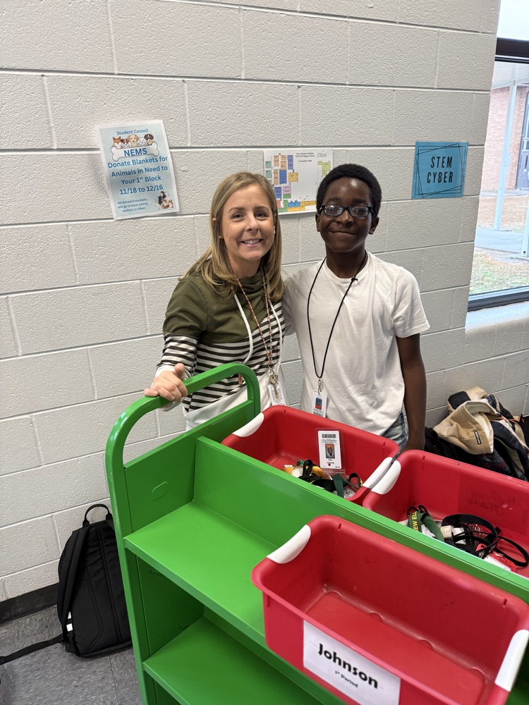 student standing with teacher 