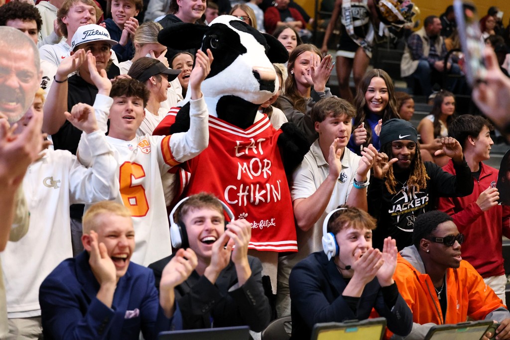Students cheering with chick-fil-a cow.