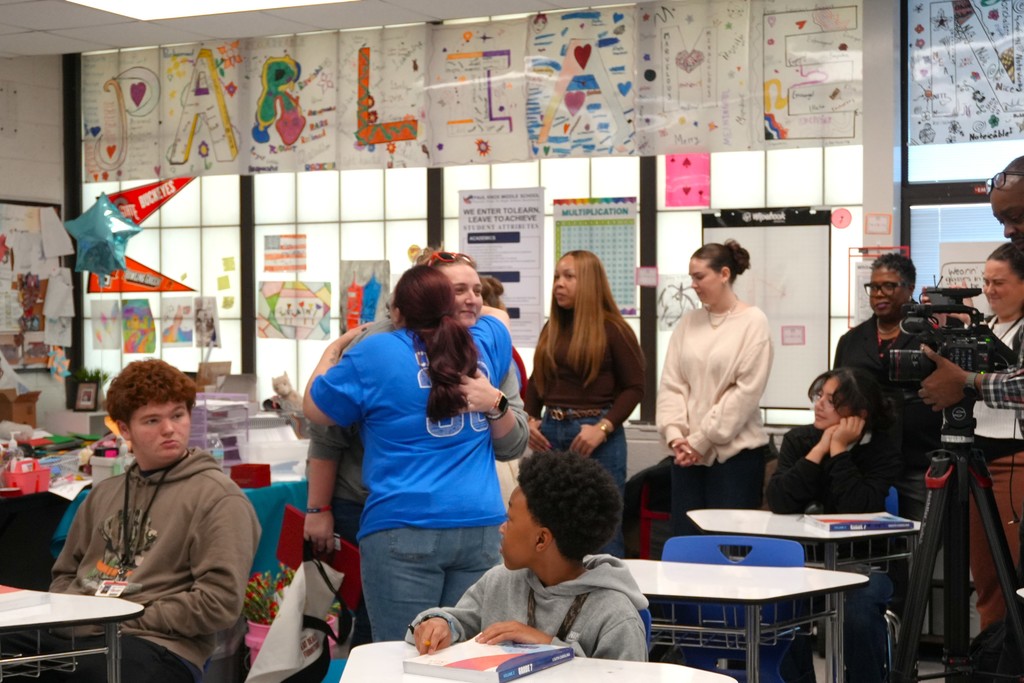 Heather Parliament hugs another adult.