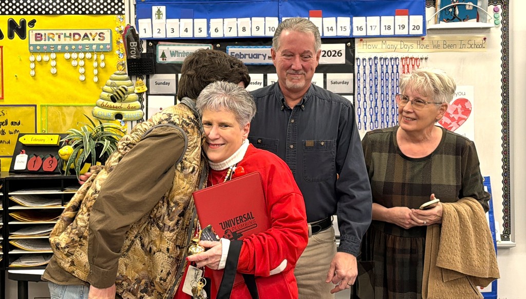 Christine Witt hugs her family.