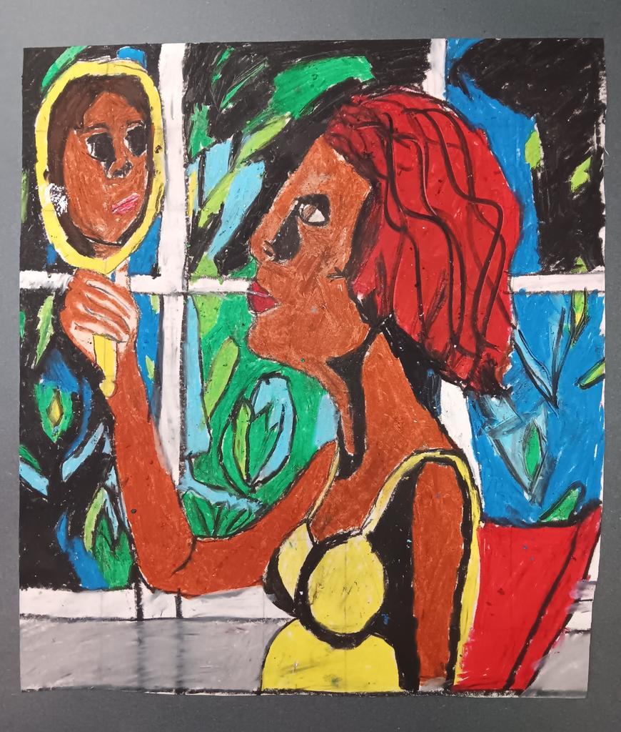 African American woman sitting in chair holding a mirror.