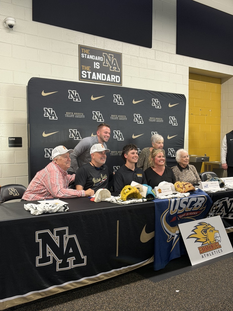 One student athlete family smile for a photo.