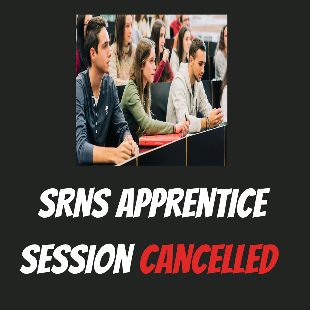 Students sitting in auditorium listening to lecture.