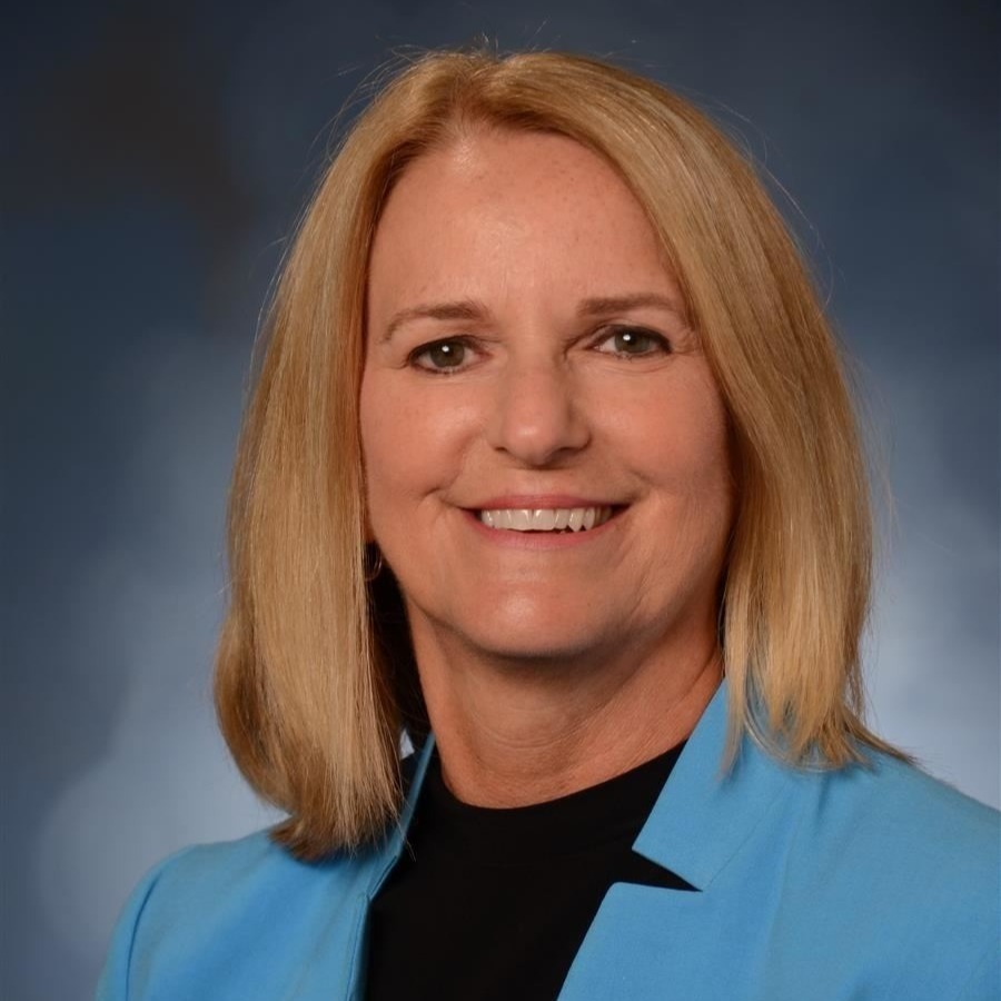 Julie Revelle in blue blazer.