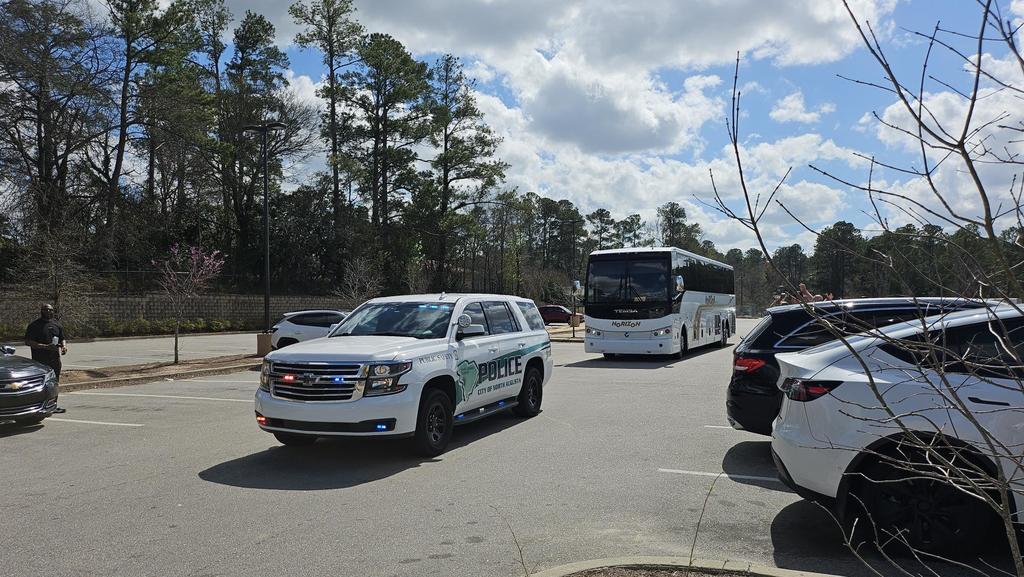 Police escorting bus of players to state game. 