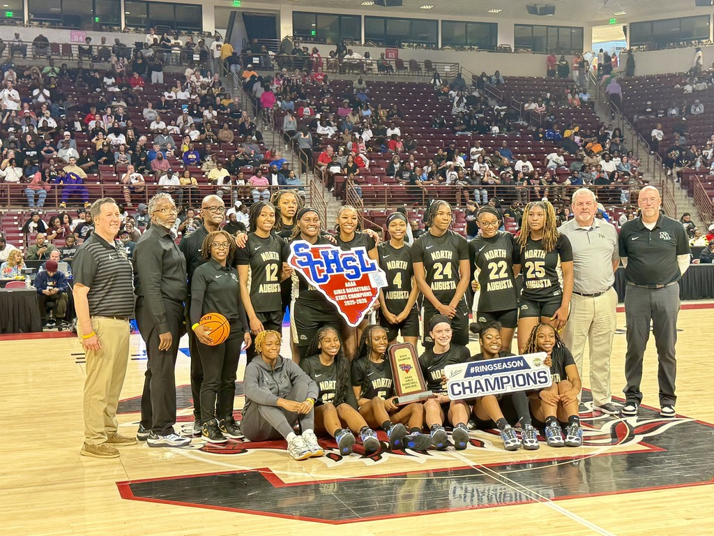 Girl basketball team with coaches and administrations with win sign in arena. 