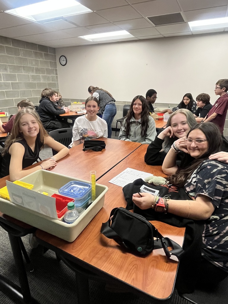 students measuring the mass of different minerals