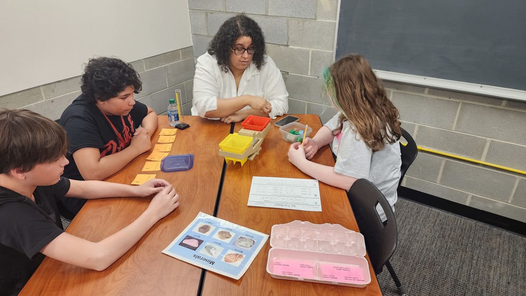 students measuring the mass of different minerals