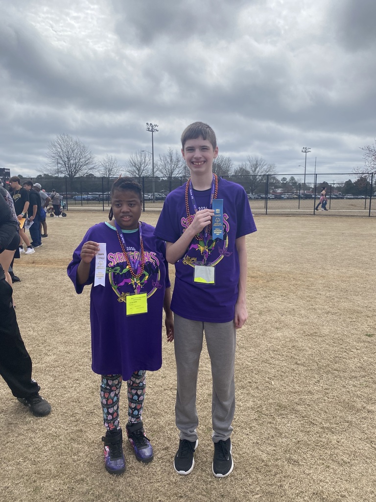 Children in field holding ribbons