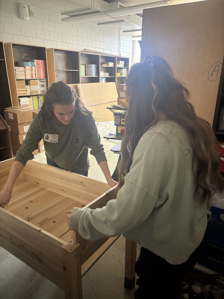 Parent assembling raised planter.