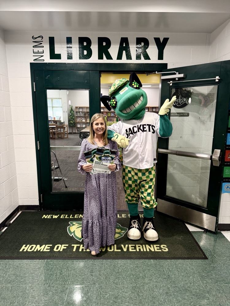 students posing with a baseball mascot that resembles a bug