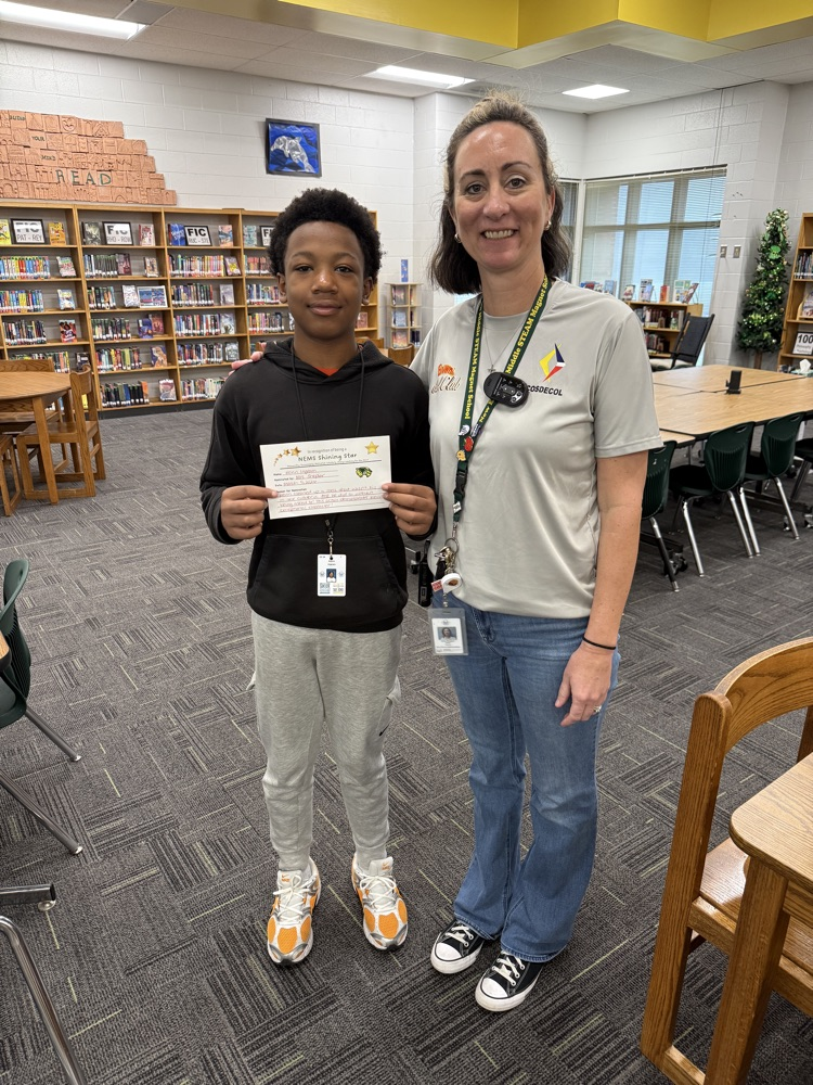 student posing with his teacher and a certificate