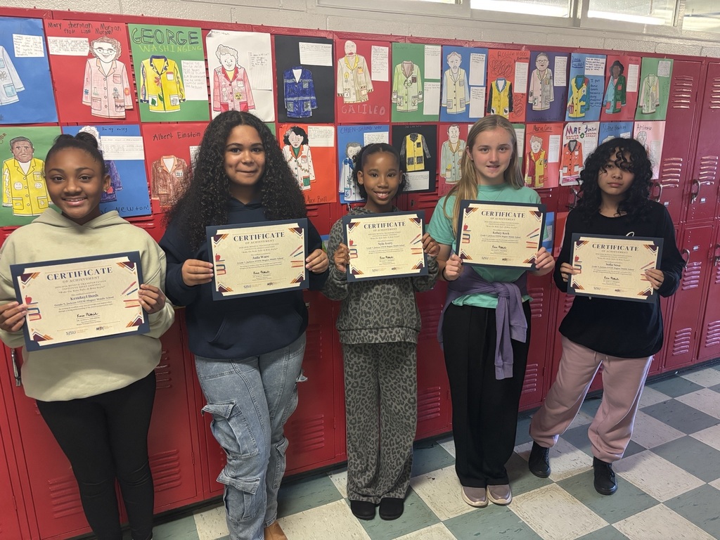 Students holding up a certificate for entering an essay contest.