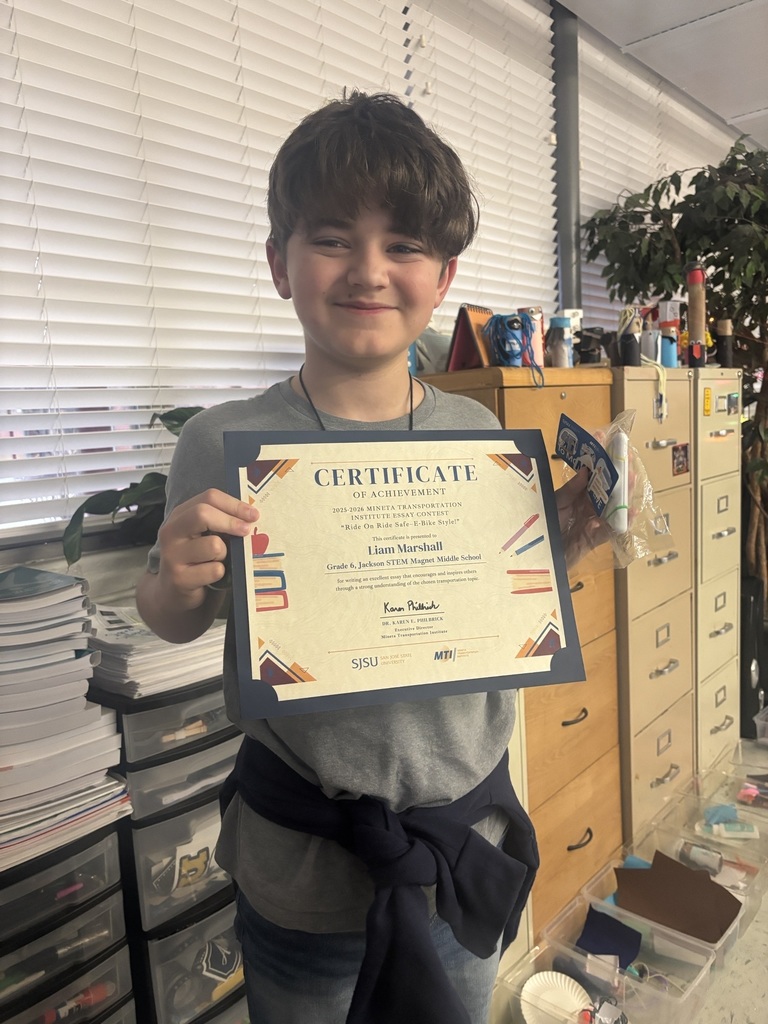 Student holding up a certificate for entering an essay contest.