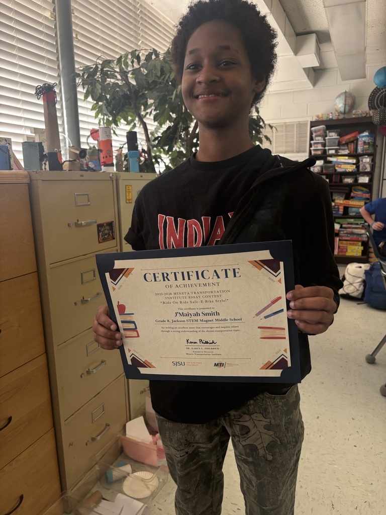 Student holding up a certificate for entering an essay contest.