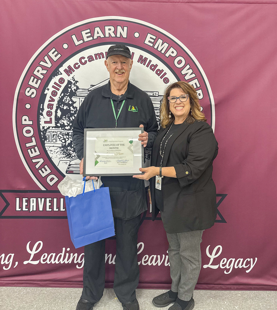 Child Nutrition Employee George Howe Stands with Child Nutrition Coordinator Polly Peyinghaus for a photo