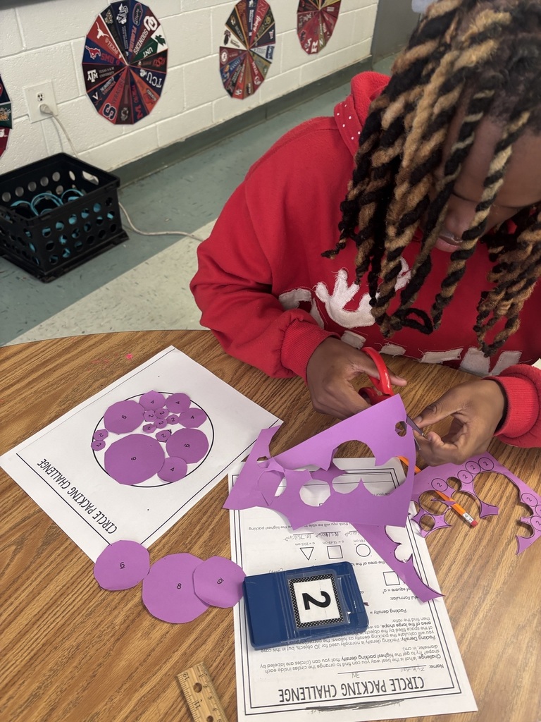 Student cutting our Pi activity pieces.