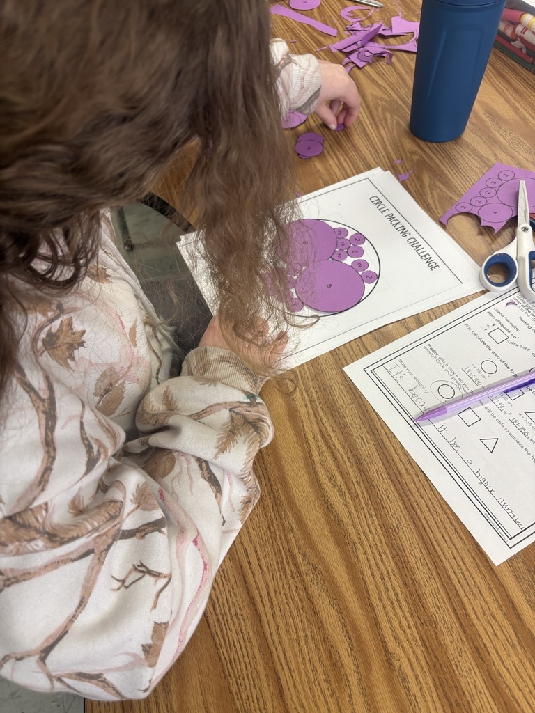 Student arranging Pi activity pieces on a worksheet.