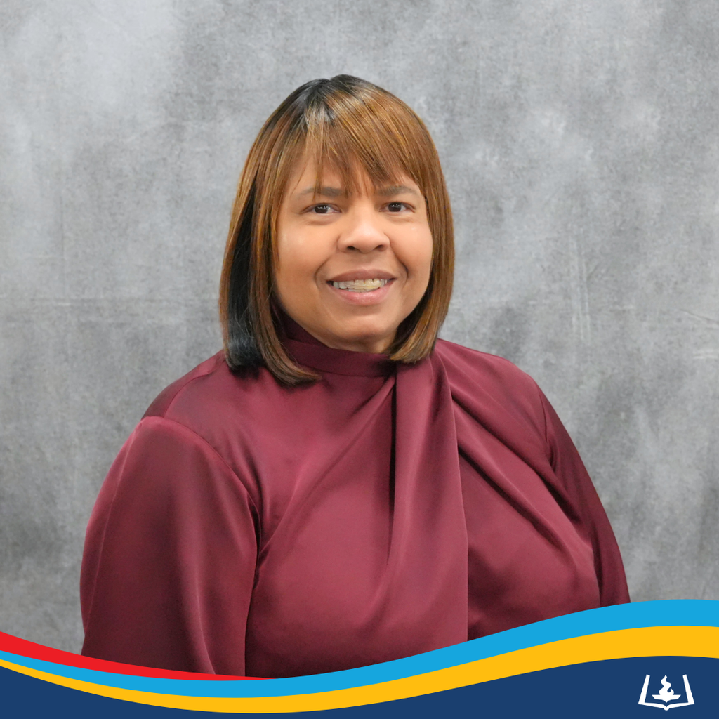 Vicki smiling in maroon blouse.