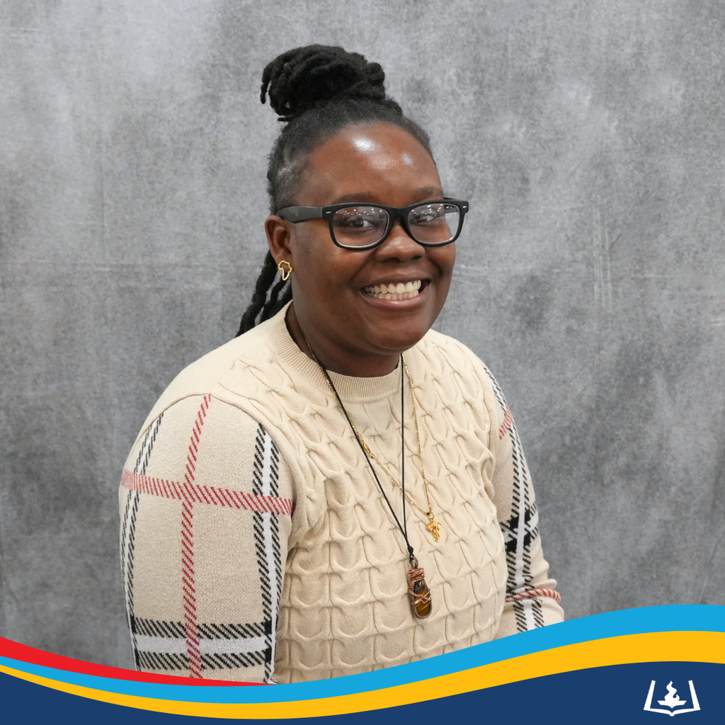 Whitney smiling in light sweater.