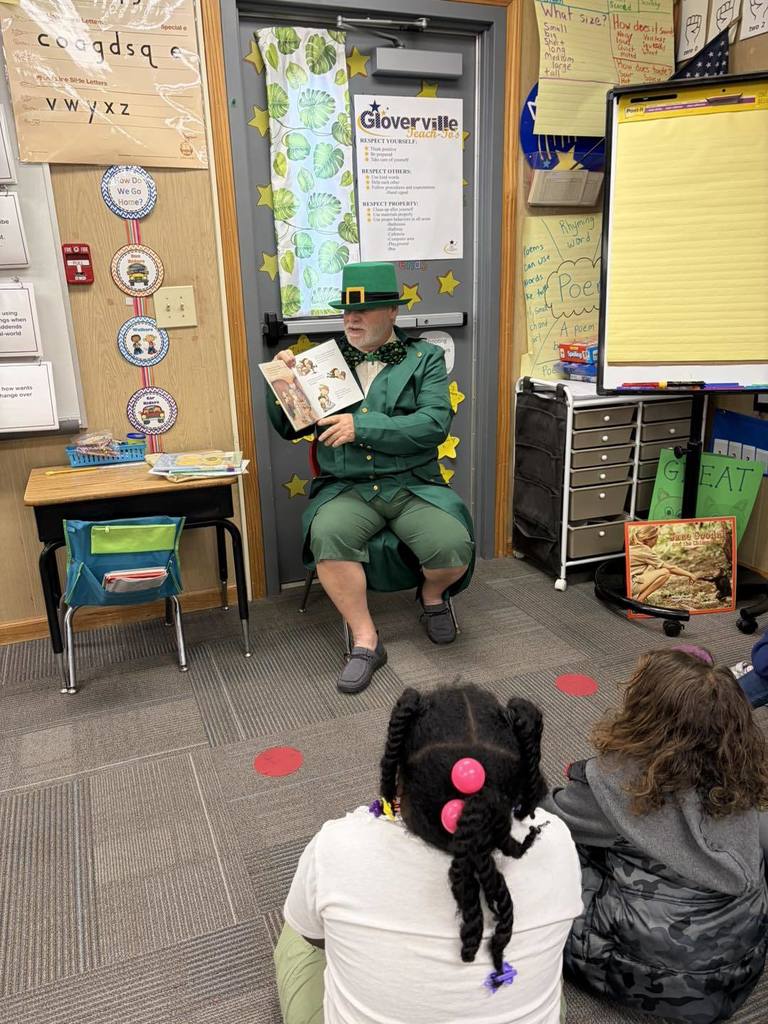 A leprechaun reads to students at Gloverville Elementary.