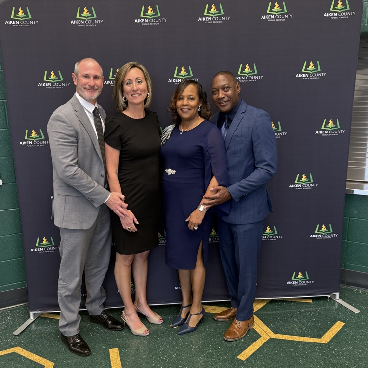 four people posing for a picture 