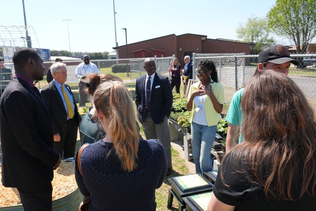 Group of leadership listening to South Aiken student speak about their garden.