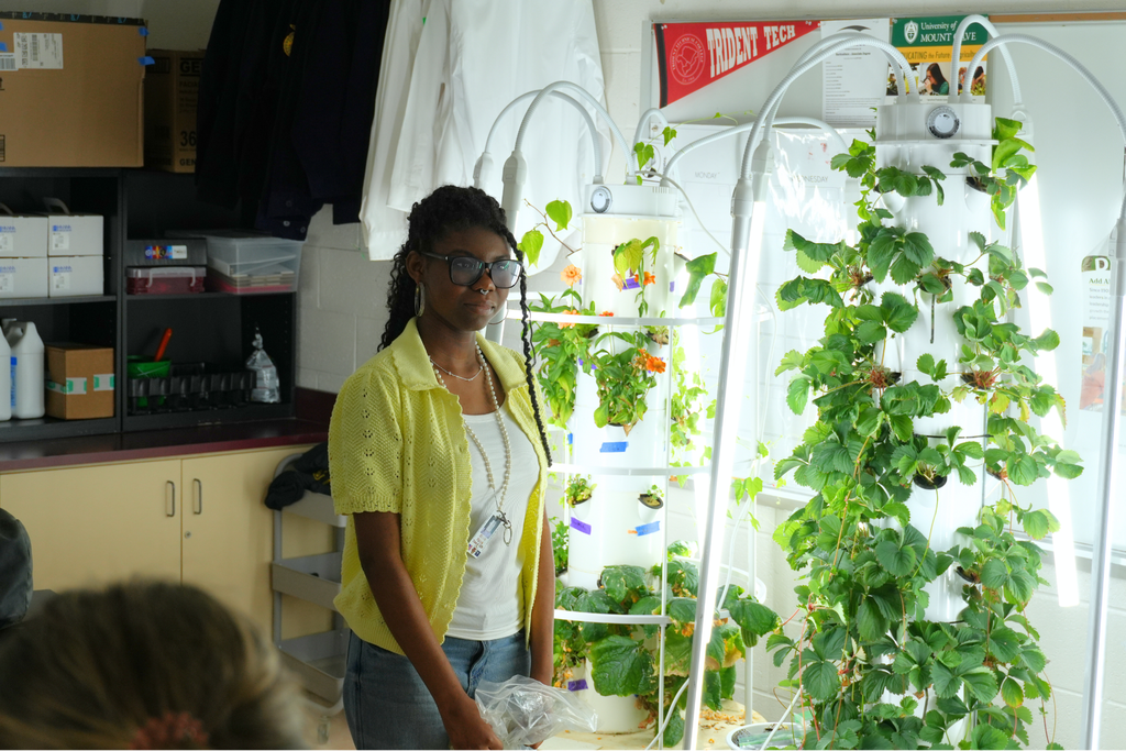 South Aiken High School student in front of plant towers.