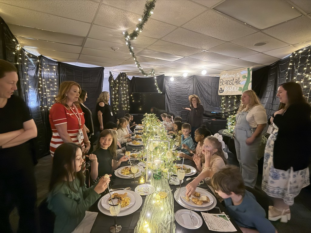Parent volunteers help students with lunch in transformed bistro classrooms.