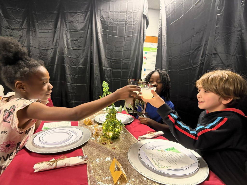 Students clink glasses together.