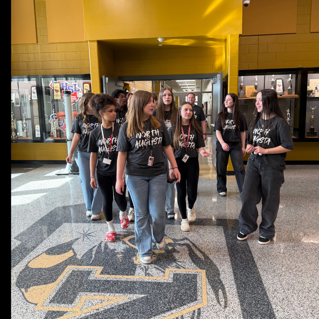 Students walking in hallway all wearing NAHS shirts.
