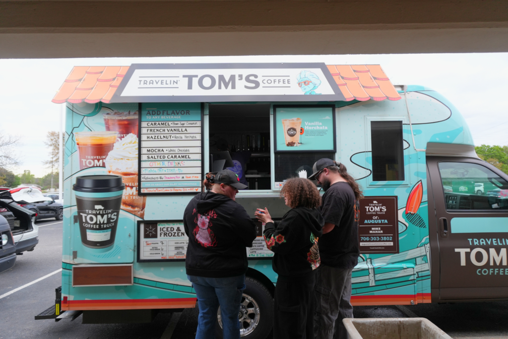 Family ordering coffee from Travelin' Tom's Coffee food truck.