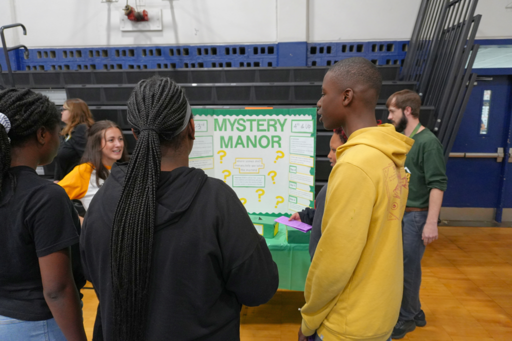 Students participating in Mystery Manor table.
