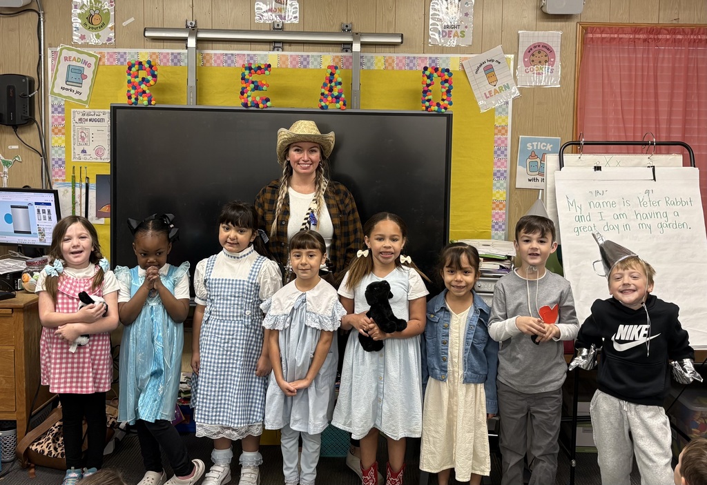 children and a teacher dressed like the characters from the Wonderful Wizard of Oz