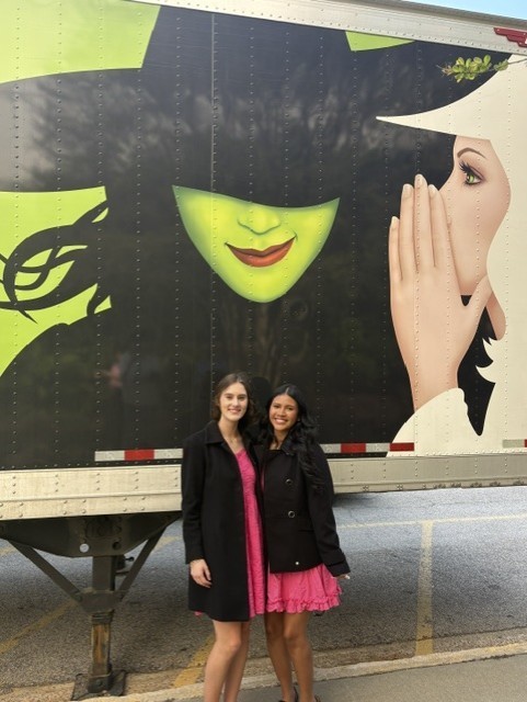 Wicked set truck with two girls standing in front.