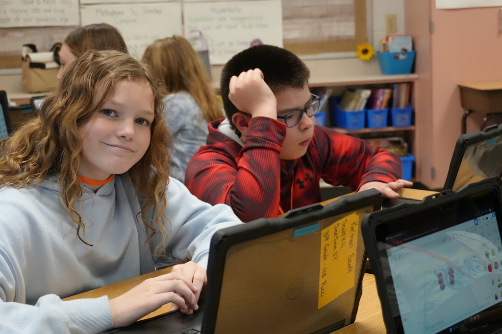 students working at a desk. 