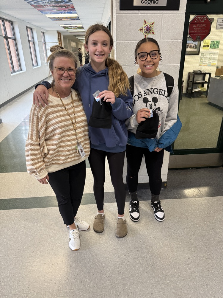 teacher posing with students 