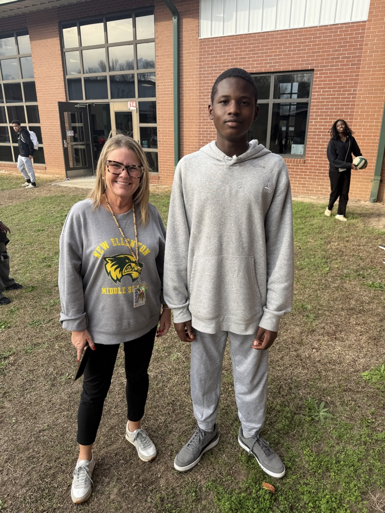 teacher posing with students 
