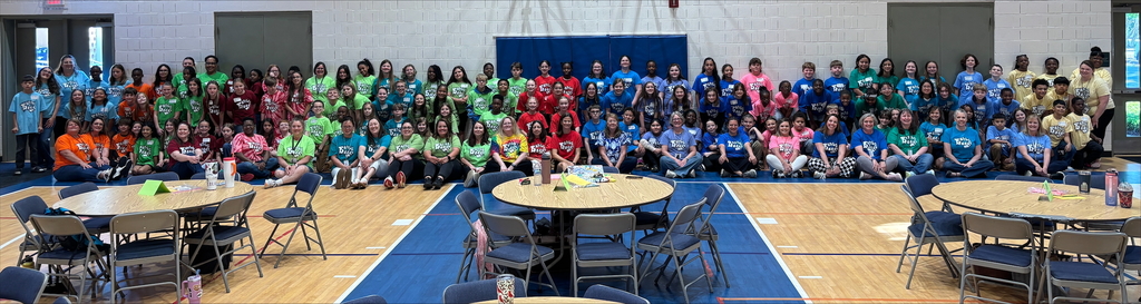 elementary teams for the Battle of the Books posing for a picture in a gym