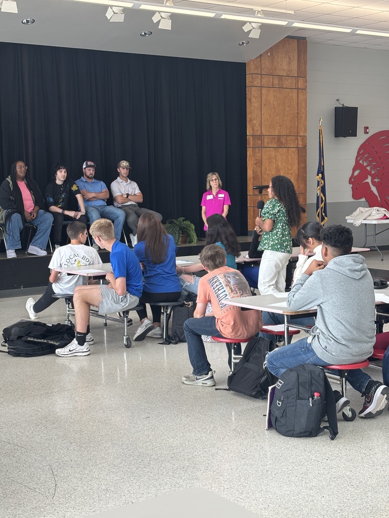 Female student asking panel a question.