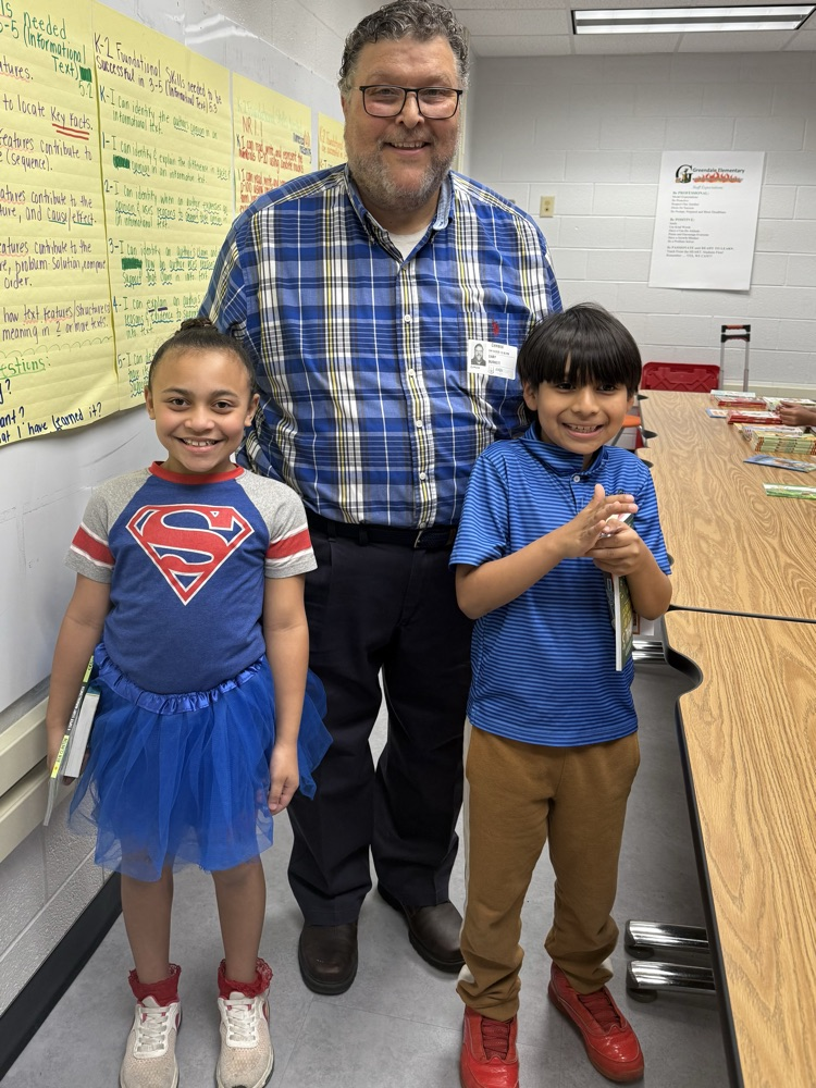 Mr. Burnett and 2nd grade students after they picked out their free books 