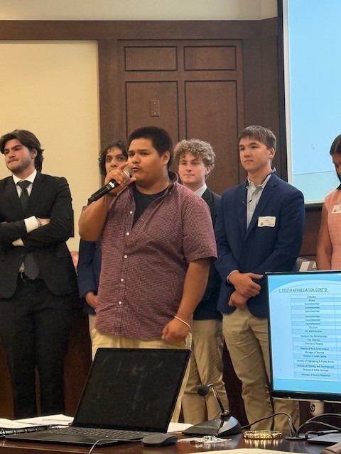 Student speaking at chamber meeting. 
