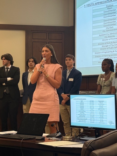 Student speaking at chamber meeting. 