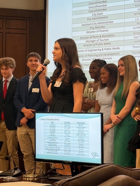 Student speaking at chamber meeting. 