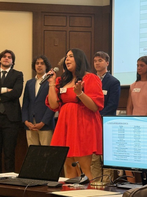 Student speaking at chamber meeting. 