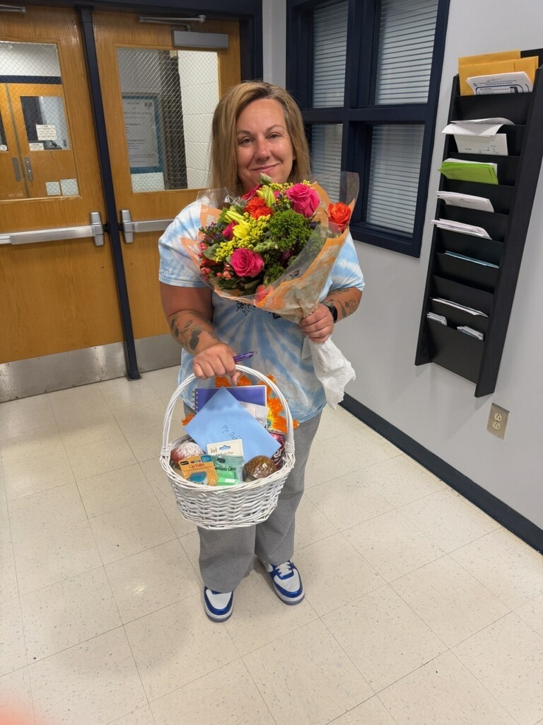 Lady holding flowers and a basket